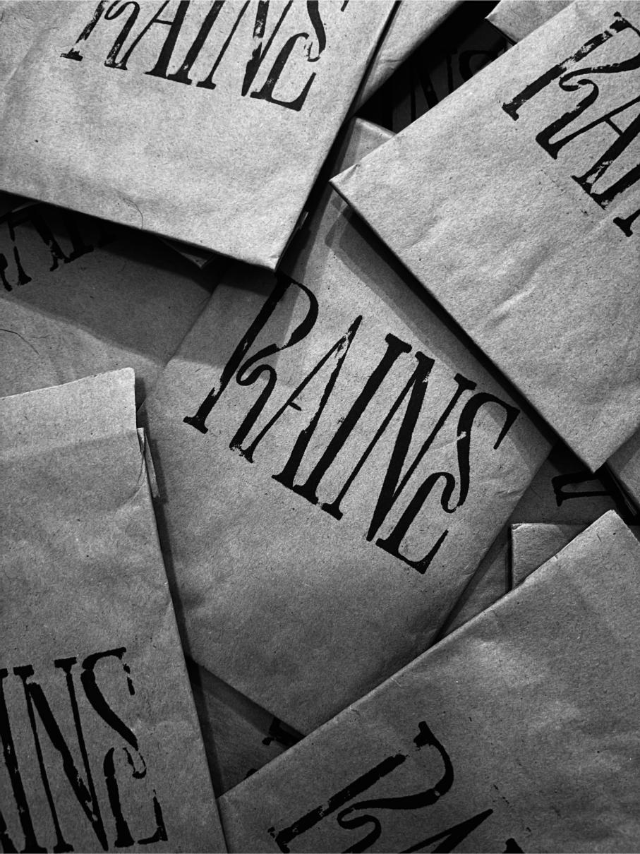 Black and white photo of Raine Waistbeads paper mailers